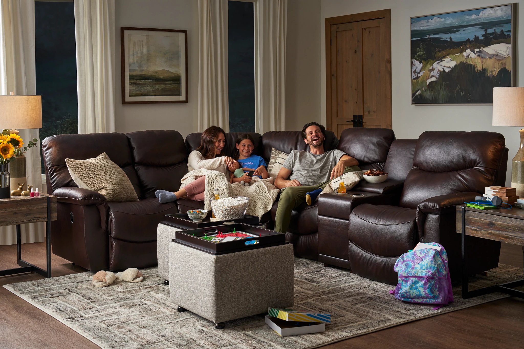 family enjoying reclining leather sofa from la-z-boy